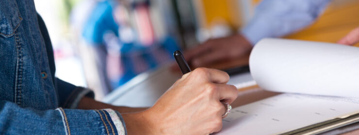Woman filling out registration form at an event