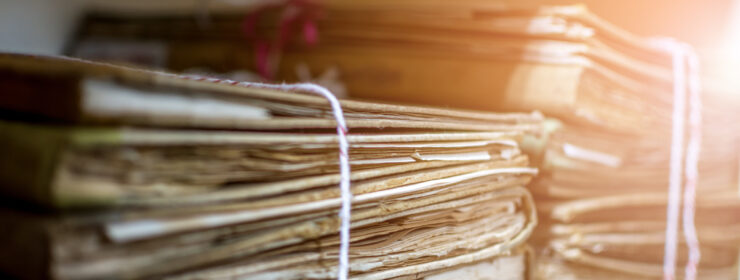 Paper files in a folder is a old documents or old letter it's a age-old and ancient archiving by stacking up in a documents paper shelf messy order