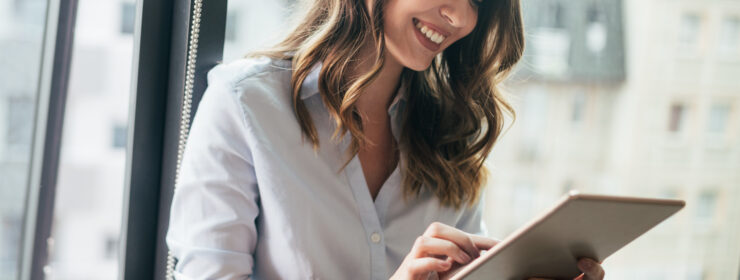 Smiling colleague working on a tablet