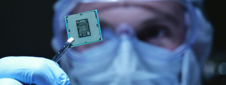 Design Engineer in Sterile Coverall Holds Microchip