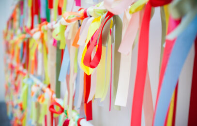 Closeup on colorful wish ribbons in a row.