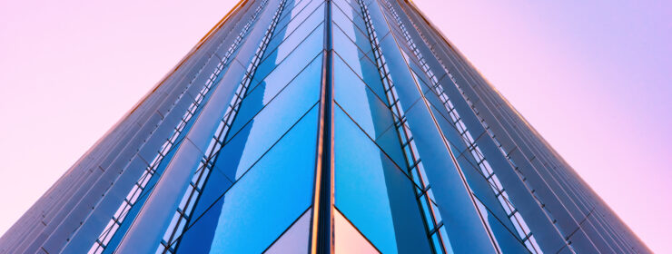 An urban downtown skyscraper shot at the corner from below at dusk in downtown Austin, Texas.