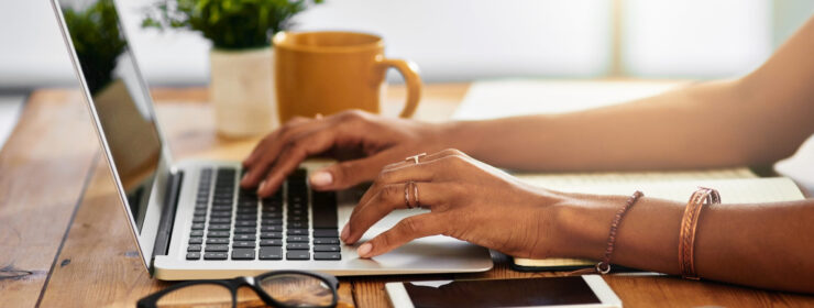 Shot of an unrecognizable woman working from home