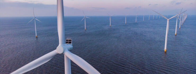 Windmill park green energy during sunset in the ocean