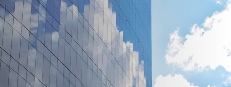 Reflection of clouds and sky on modern glass building