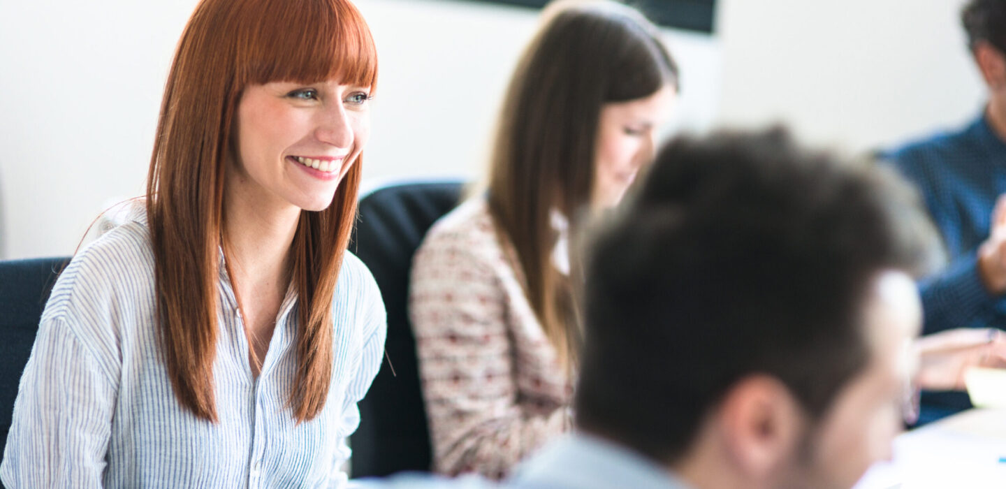 Smiling colleague in group meeting