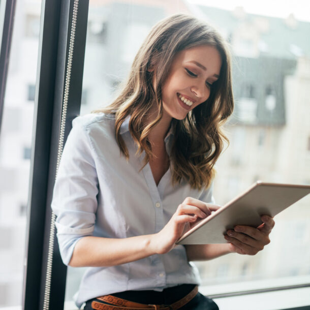 Smiling colleague working on a tablet