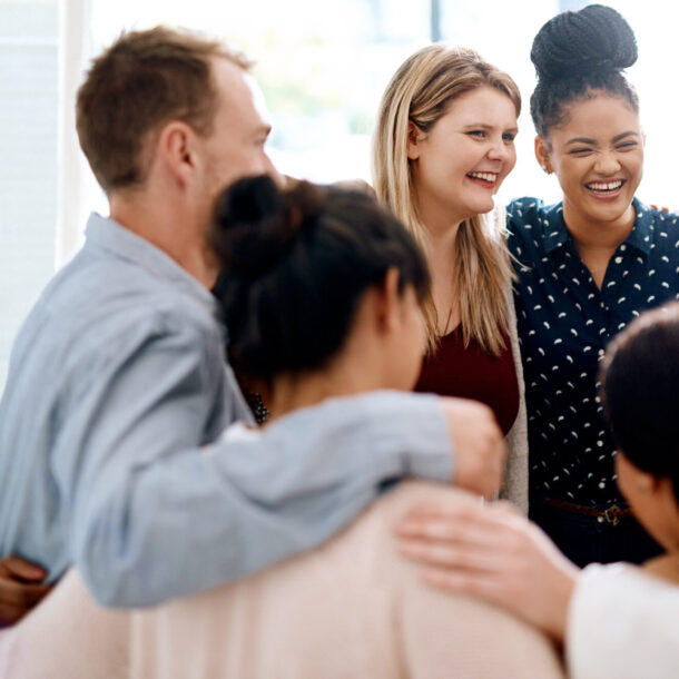 Smiling group embrace